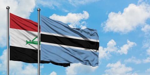 Iraq and Botswana flag waving in the wind against white cloudy blue sky together. Diplomacy...