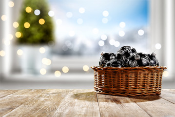 Table background of free space for your decoration and winter window background.Christmas tree.Winter landscape of mountains. Blurred lights.Copy space. 