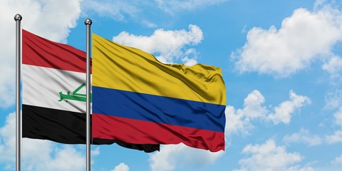 Iraq and Colombia flag waving in the wind against white cloudy blue sky together. Diplomacy concept, international relations.