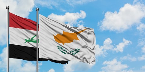 Iraq and Cyprus flag waving in the wind against white cloudy blue sky together. Diplomacy concept, international relations.