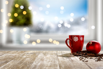 Table background of free space for your decoration and winter window background.Christmas tree.Winter landscape of mountains. Blurred lights.Copy space. 