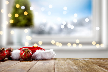 Table background of free space for your decoration and winter window background.Christmas tree.Winter landscape of mountains. Blurred lights.Copy space. 