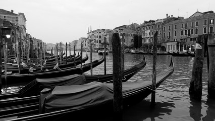 Fototapeta premium Black and white photo of gondola and gondolier taken in the beautiful city of Venice, Italy