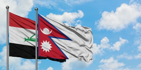 Iraq and Nepal flag waving in the wind against white cloudy blue sky together. Diplomacy concept, international relations.