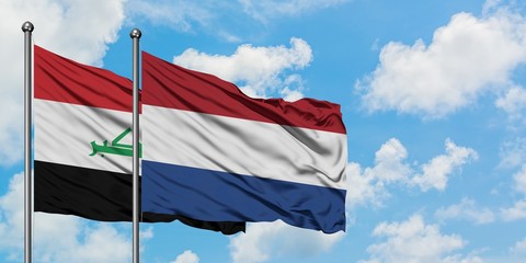 Iraq and Netherlands flag waving in the wind against white cloudy blue sky together. Diplomacy concept, international relations.