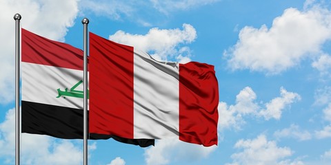 Iraq and Peru flag waving in the wind against white cloudy blue sky together. Diplomacy concept, international relations.