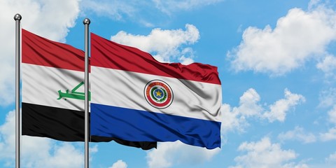 Iraq and Paraguay flag waving in the wind against white cloudy blue sky together. Diplomacy concept, international relations.