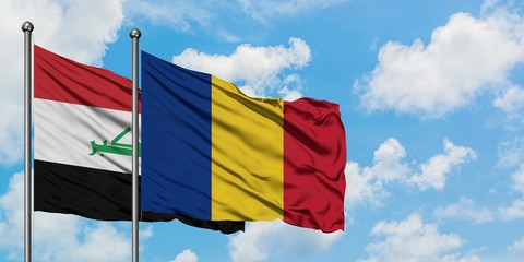 Iraq and Romania flag waving in the wind against white cloudy blue sky together. Diplomacy concept,...