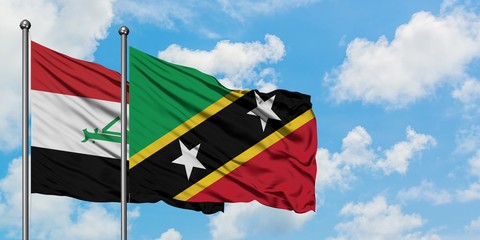 Iraq and Saint Kitts And Nevis flag waving in the wind against white cloudy blue sky together. Diplomacy concept, international relations.