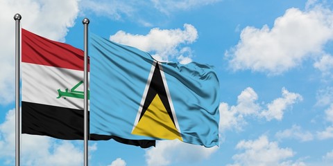 Iraq and Saint Lucia flag waving in the wind against white cloudy blue sky together. Diplomacy concept, international relations.