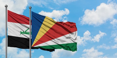 Iraq and Seychelles flag waving in the wind against white cloudy blue sky together. Diplomacy...