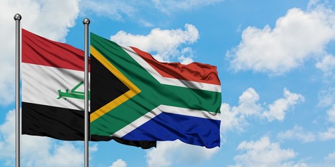 Iraq and South Africa flag waving in the wind against white cloudy blue sky together. Diplomacy concept, international relations.