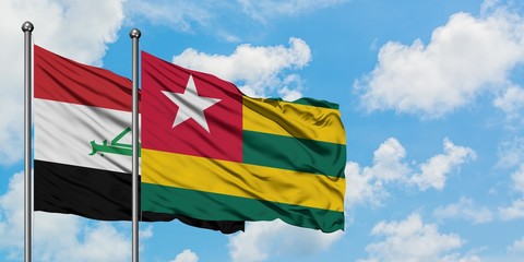 Iraq and Togo flag waving in the wind against white cloudy blue sky together. Diplomacy concept, international relations.