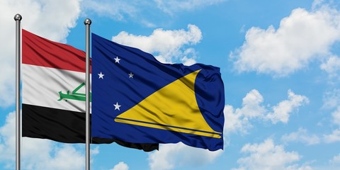 Iraq and Tokelau flag waving in the wind against white cloudy blue sky together. Diplomacy concept, international relations.