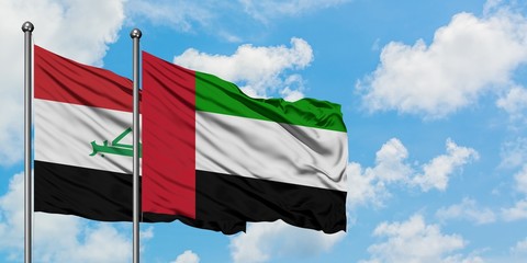 Iraq and United Arab Emirates flag waving in the wind against white cloudy blue sky together. Diplomacy concept, international relations.
