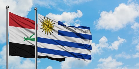 Iraq and Uruguay flag waving in the wind against white cloudy blue sky together. Diplomacy concept, international relations.