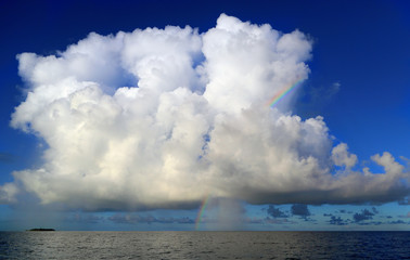 Naklejka na ściany i meble Rainbow and white lush cloud over the Indian Ocean, Maldives