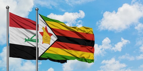 Iraq and Zimbabwe flag waving in the wind against white cloudy blue sky together. Diplomacy concept, international relations.