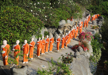Statues of Buddhist monks going to prayer in the cave temple of Dambulla, Sri Lanka