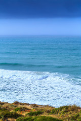 A huge waves on the ocean coast in a shine bright light  at sunny day. Wonderful romantic seascape of ocean coastline.