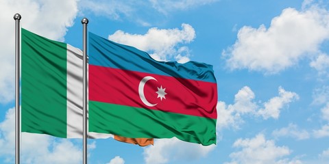 Ireland and Azerbaijan flag waving in the wind against white cloudy blue sky together. Diplomacy concept, international relations.