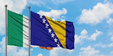 Ireland and Bosnia Herzegovina flag waving in the wind against white cloudy blue sky together. Diplomacy concept, international relations.