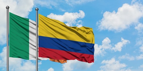 Ireland and Colombia flag waving in the wind against white cloudy blue sky together. Diplomacy concept, international relations.