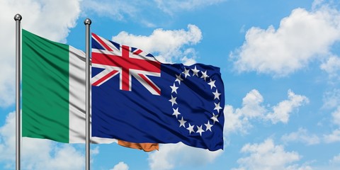 Ireland and Cook Islands flag waving in the wind against white cloudy blue sky together. Diplomacy...