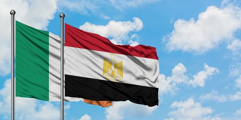 Ireland and Egypt flag waving in the wind against white cloudy blue sky together. Diplomacy...