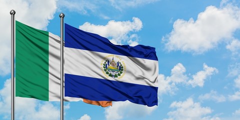 Ireland and El Salvador flag waving in the wind against white cloudy blue sky together. Diplomacy...