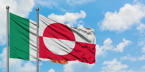 Ireland and Greenland flag waving in the wind against white cloudy blue sky together. Diplomacy...