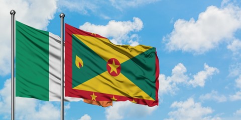 Ireland and Grenada flag waving in the wind against white cloudy blue sky together. Diplomacy concept, international relations.