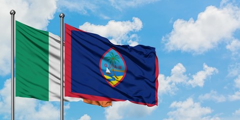Ireland and Guam flag waving in the wind against white cloudy blue sky together. Diplomacy concept, international relations.