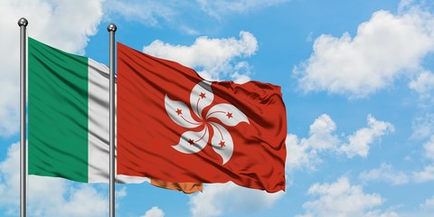 Ireland and Hong Kong flag waving in the wind against white cloudy blue sky together. Diplomacy concept, international relations.