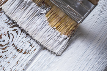 The process of painting paintbrush wooden surface of old(rustic) brown wood planks on white color....