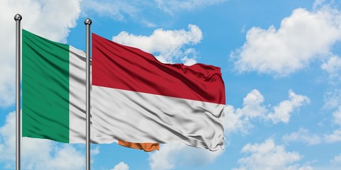 Ireland and Indonesia flag waving in the wind against white cloudy blue sky together. Diplomacy concept, international relations.