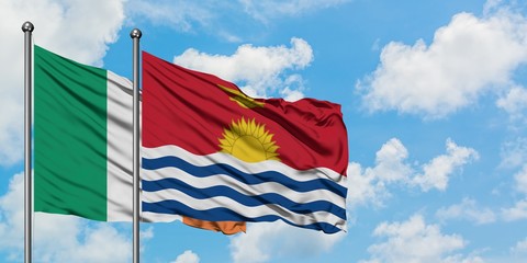 Ireland and Kiribati flag waving in the wind against white cloudy blue sky together. Diplomacy concept, international relations.
