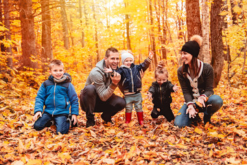 A portrait of a young family in the autumn park