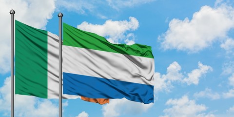Ireland and Sierra Leone flag waving in the wind against white cloudy blue sky together. Diplomacy concept, international relations.