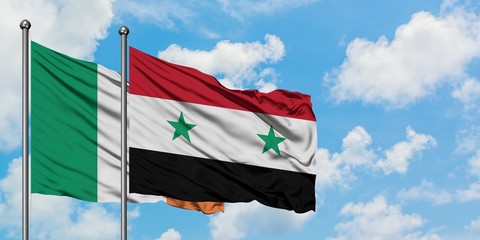 Ireland and Syria flag waving in the wind against white cloudy blue sky together. Diplomacy concept, international relations.