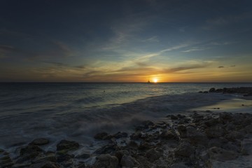 Gorgeous colorful view of sunset on Aruba. Beautiful nature landscape. Rocky coast of Atlanta, Caribbean.	