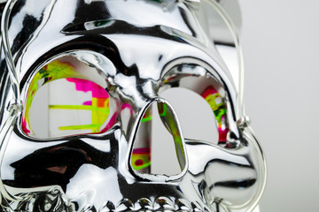 Close up of the eye sockets, nose and cheek bones of a shiny chrome effect skull mask with bubble...