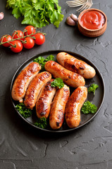 Fried sausage with fresh parsley on plate