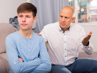 Fototapeta premium Man scolding son at home