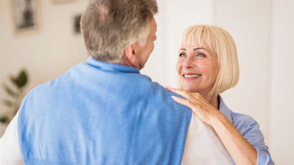 Fototapeta premium Happy senior couple dancing and smiling to each other