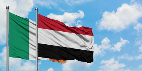 Ireland and Yemen flag waving in the wind against white cloudy blue sky together. Diplomacy concept, international relations.