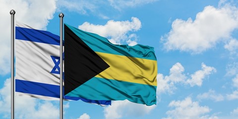 Israel and Bahamas flag waving in the wind against white cloudy blue sky together. Diplomacy concept, international relations.