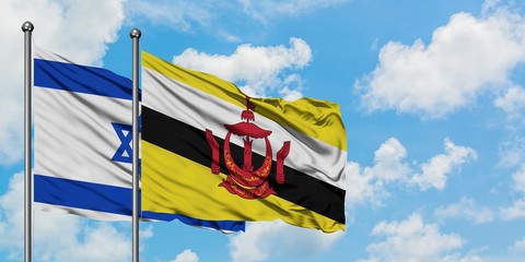 Israel and Brunei flag waving in the wind against white cloudy blue sky together. Diplomacy concept, international relations.