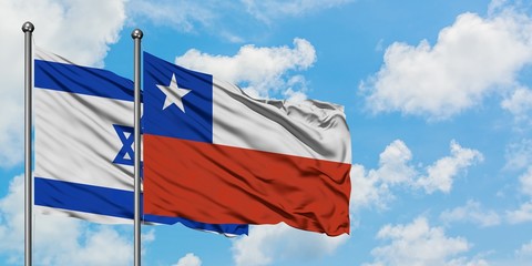 Israel and Chile flag waving in the wind against white cloudy blue sky together. Diplomacy concept, international relations.