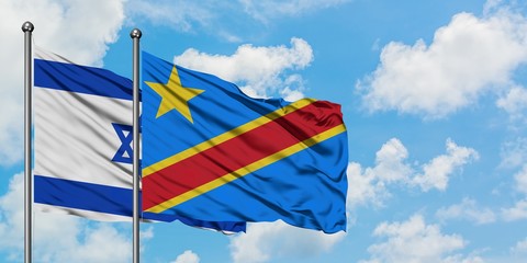 Israel and Congo flag waving in the wind against white cloudy blue sky together. Diplomacy concept, international relations.